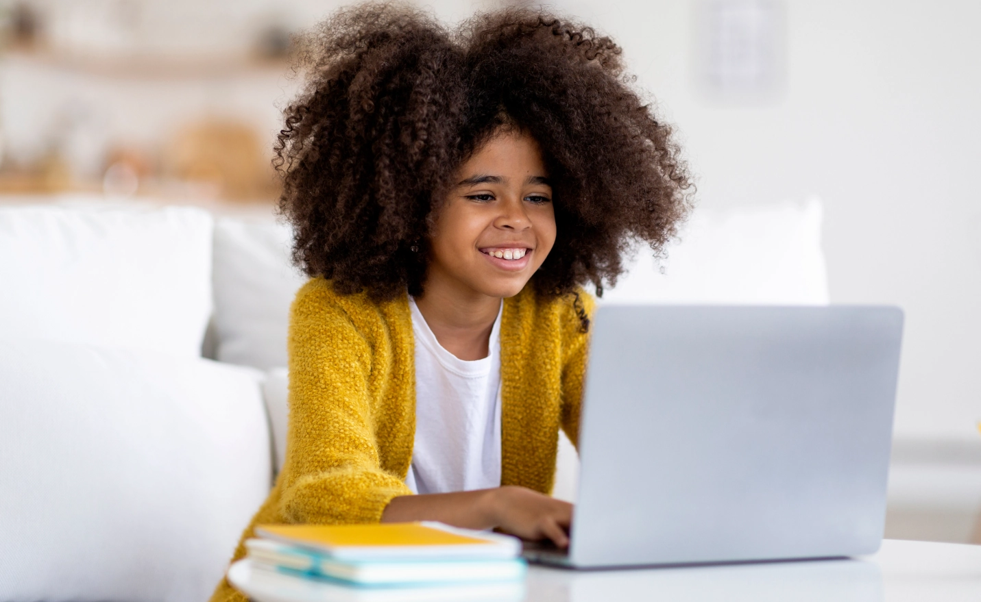 cheerful-black-girl-schooler-doing-homework-using-2023-11-27-04-58-55-utc 1.webp